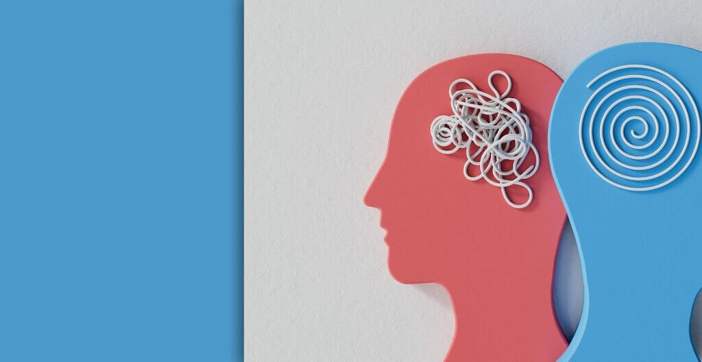 Zwei Köpfe – einer mit einem wirren Gedankenknäuel, einer mit einer sauber gedrehten Spirale. Es soll ein Sinnbild für die Wichtigkeit der Gesundheitspsychologie sein.